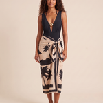 Studio view of the complete black swimsuit and halter top worn with the beige palm-print sarong.