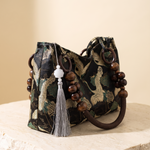 Elara embroidered tassel-detail bag – studio angle view