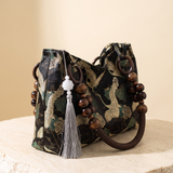 Elara embroidered tassel-detail bag – studio angle view