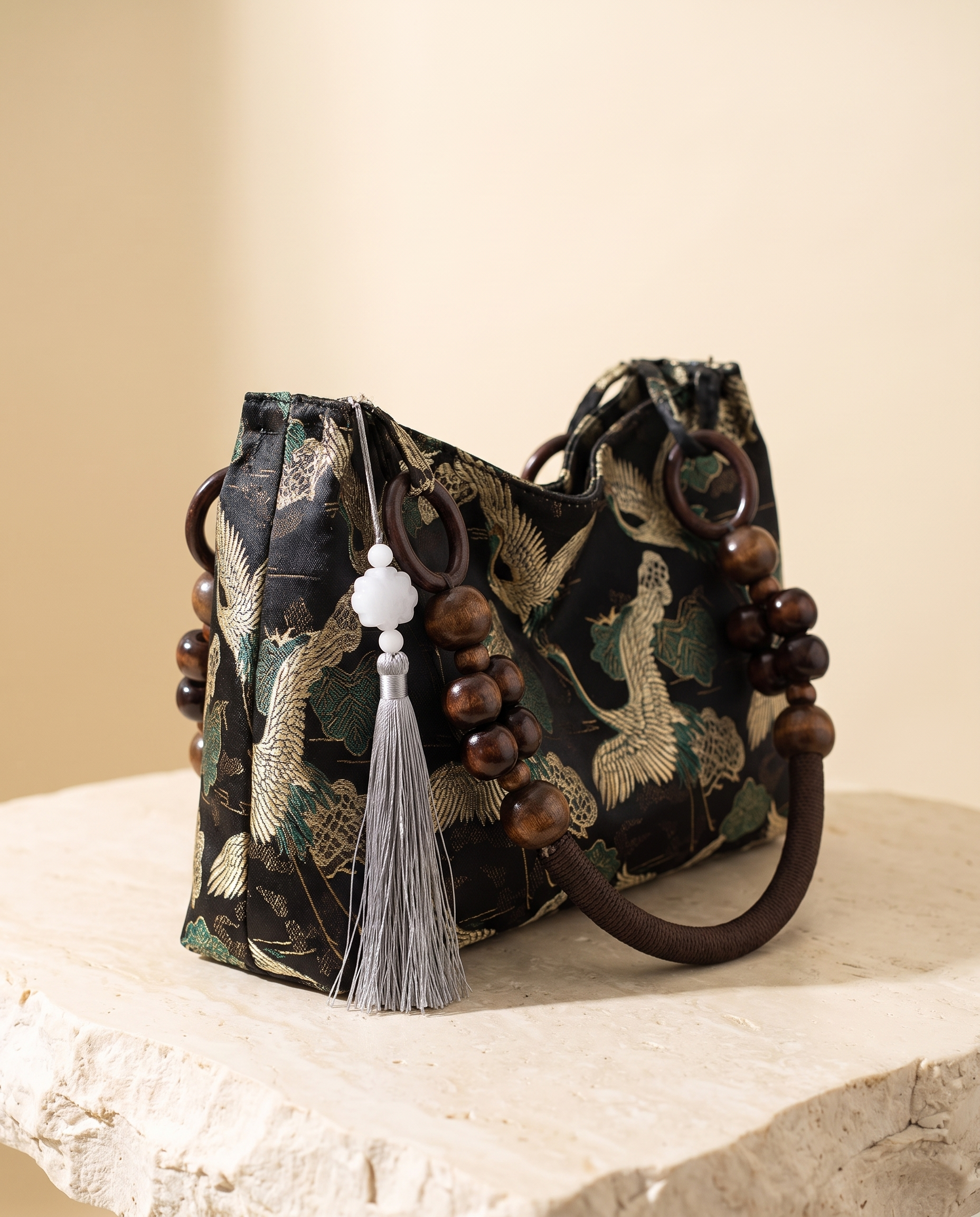 Elara embroidered tassel-detail bag – studio angle view