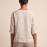 Linen Blouse with V Neck and Three Quarter Sleeves — full-length studio back view on a warm ivory seamless background