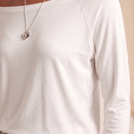Off Shoulder Long Sleeve Top with Relaxed Fit — tight editorial product detail showing the fabric texture, stitching, neckline and construction