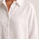 Oversized Linen Shirt with Button Front — tight editorial product detail showing the fabric texture, stitching, neckline and construction