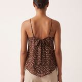 Polka Dot Chiffon Cami with Tie Back and Asymmetric Hem — full-length studio back view on a warm ivory seamless background