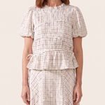 Checked top and skirt worn fabric detail