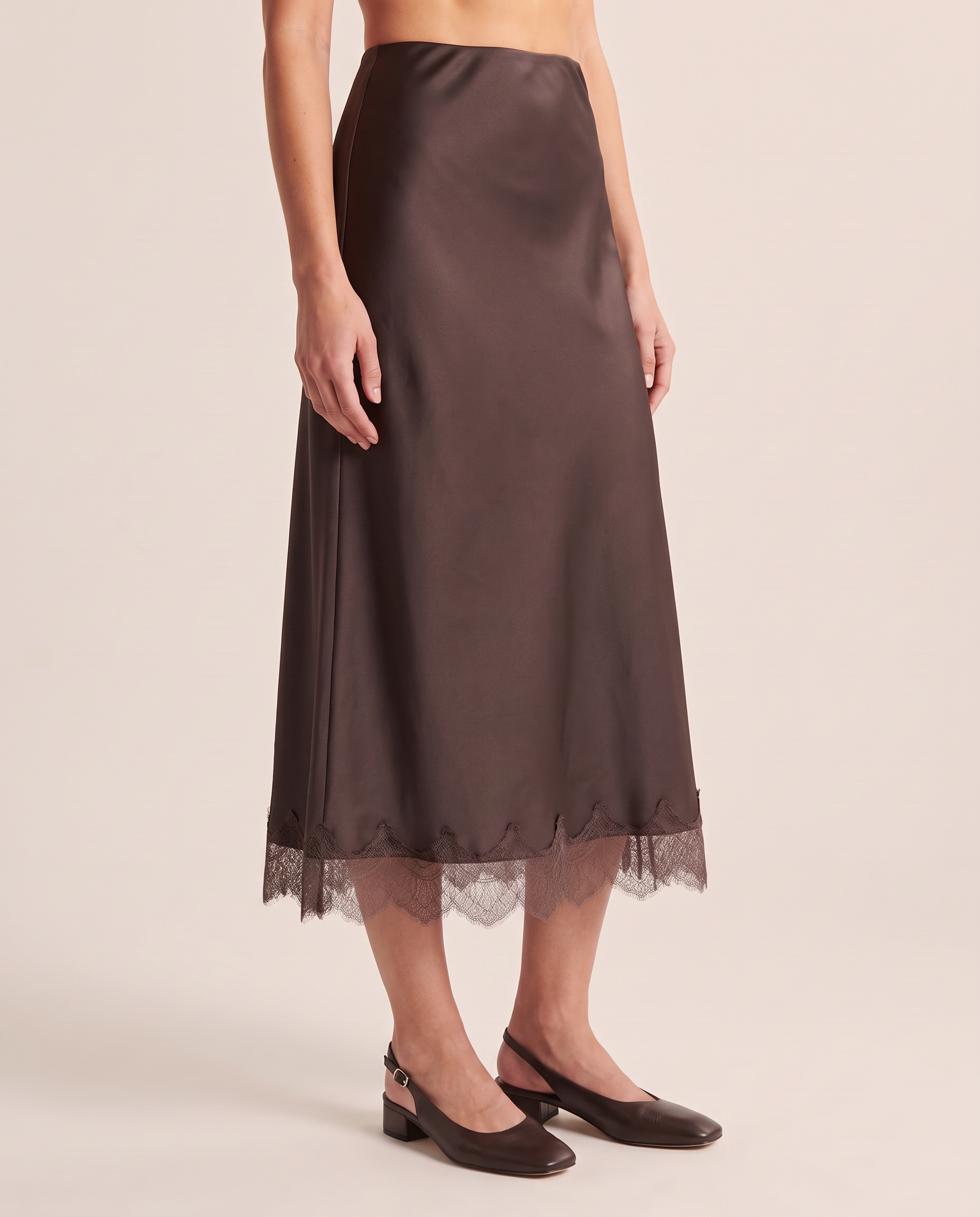 Three-quarter view of the Coffee lace trim midi skirt and its gently flared silhouette