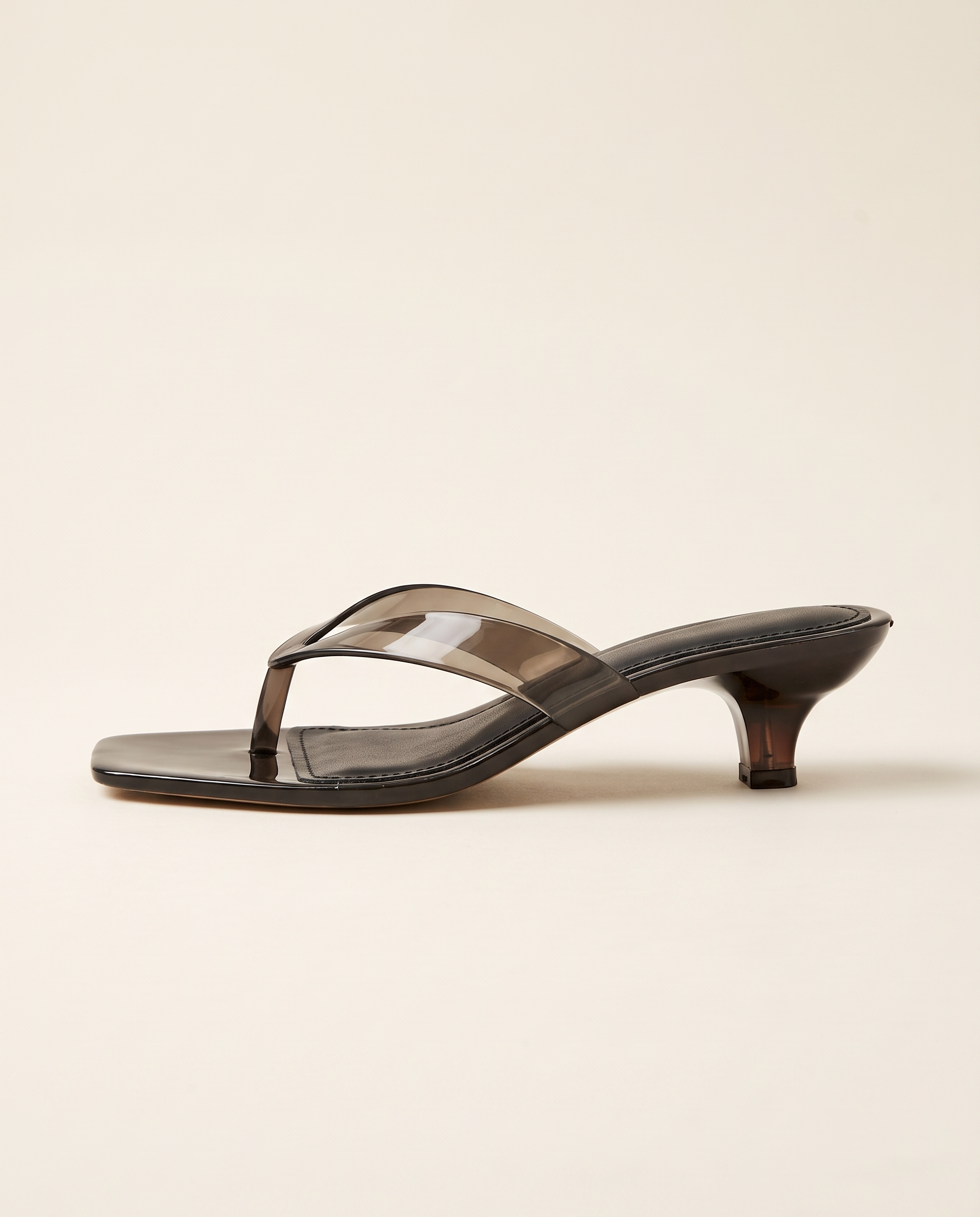 Black open-back thong sandal, low heel side profile