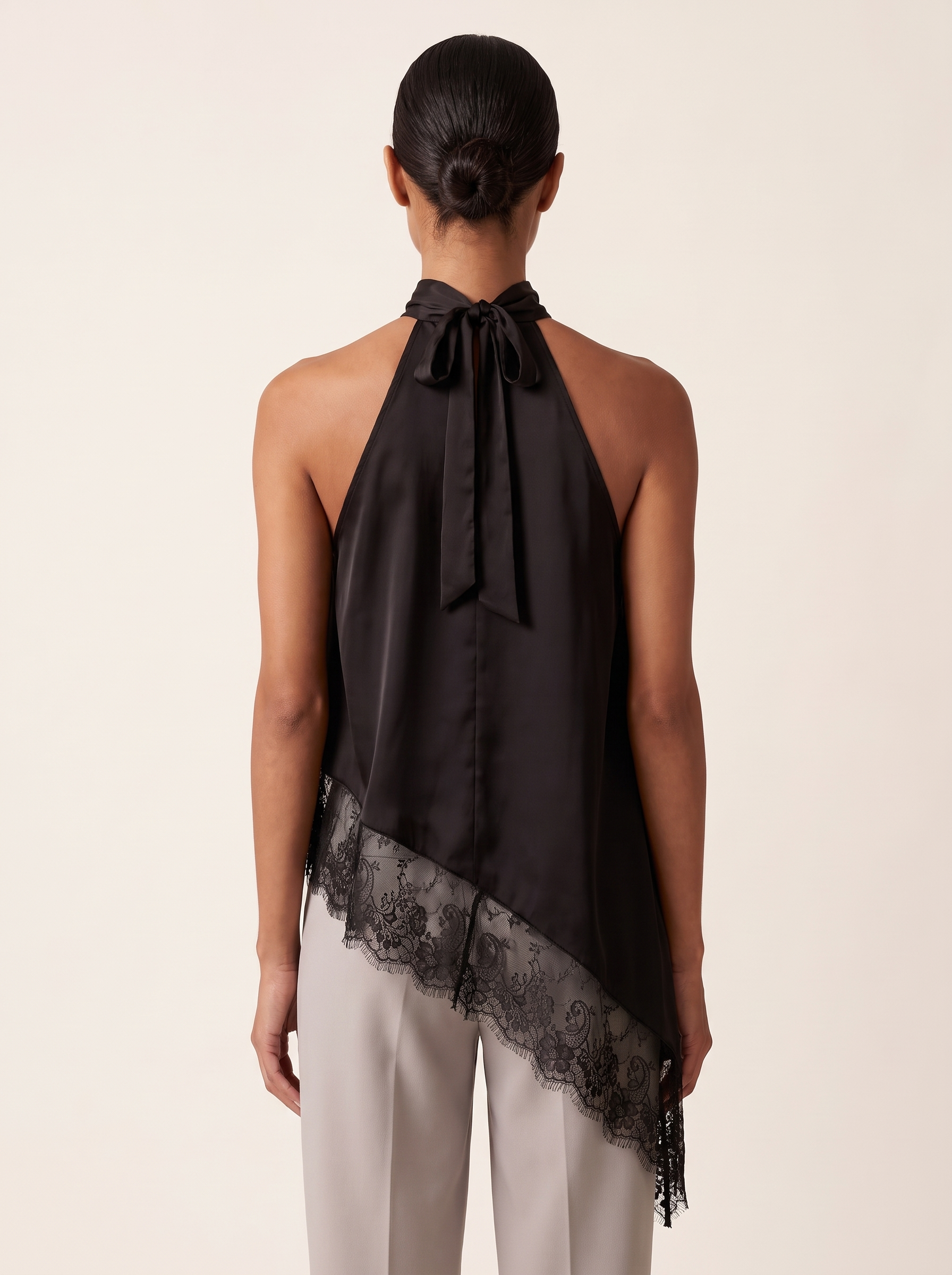 Satin and Lace Halter Top with Asymmetric Hem — full-length studio back view on a warm ivory seamless background