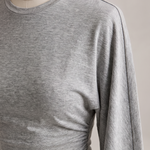 Slim Fit Long Sleeve Crop Top with Crew Neck — tight editorial product detail showing the fabric texture, stitching, neckline and construction